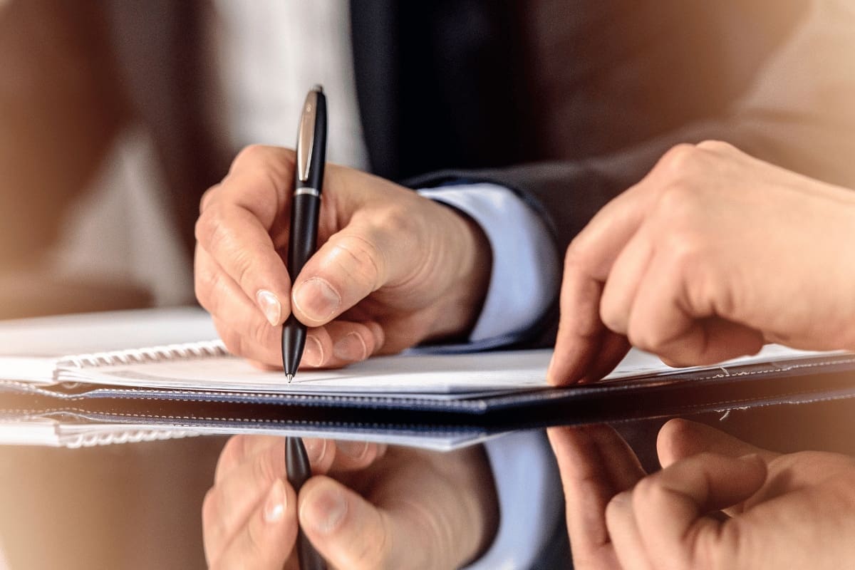 a person sign on a document
